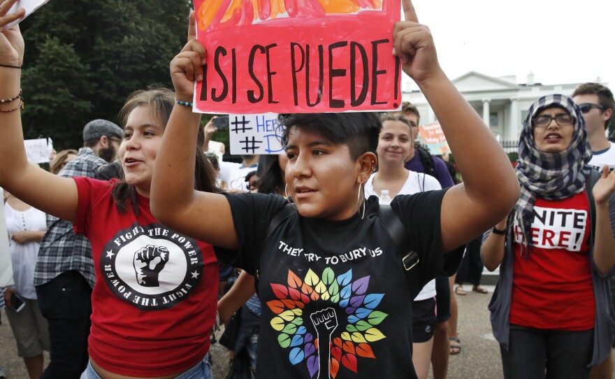 Juliana Torres (left), 16, and Micaela Lattimer, 16, both of Baltimore, rally in support of Deferred Action for Childhood Arrivals, known as DACA, outside the White House on Tuesday.