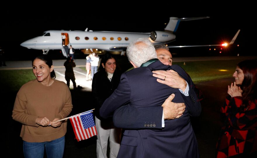 Freed U.S. national Emad Shargi greets a family member after he and four others, who were released in a prisoner swap deal between U.S. and Iran, disembark from an airplane at Davison Army Airfield at Fort Belvoir, Virginia, on September 19.