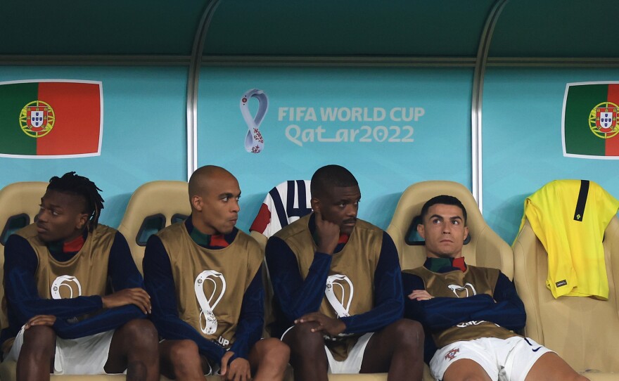 Cristiano Ronaldo of Portugal (R) reacts on the bench during the 2022 World Cup quarterfinal match against Morocco on December 10, 2022 in Doha, Qatar.