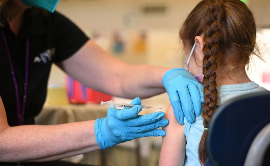 A nurse administers a pediatric dose of the Covid-19 vaccine to a girl at a L.A. Care Health Plan vaccination clinic at Los Angeles Mission College in the Sylmar neighborhood in Los Angeles, Ca., January 19, 2022.