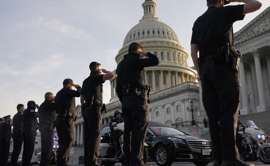 U.S. Capitol Police officers salute as the casket of slain officer William "Billy" Evans leaves the Capitol in a hearse after he was lying in honor on April 13.