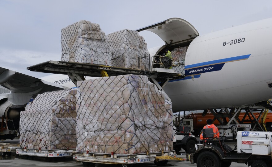 Ground crew at Los Angeles International Airport unload pallets of supplies of personal protective equipment from a China Southern Cargo plane upon its arrival on April 10.