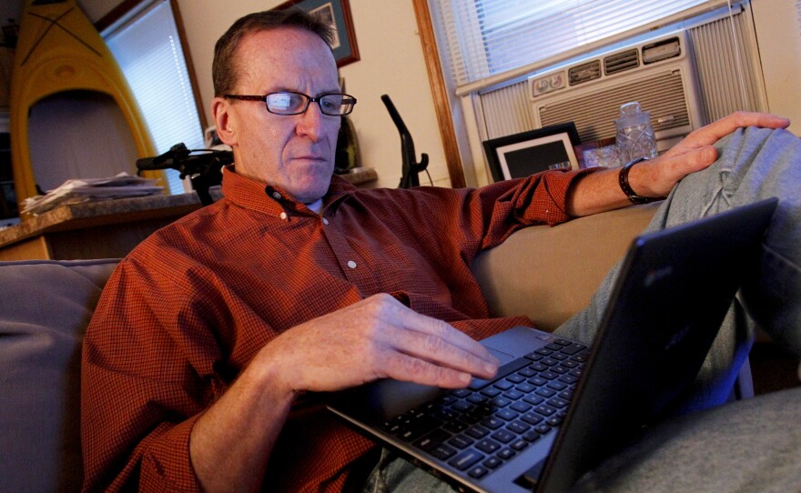 Kevin Evans relaxes in his small apartment after arriving home from work. Evans, who lost income and his home in the recession, is now having his wages garnished after falling behind on his credit card payments.