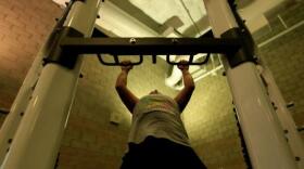 Cpl. Arianna Tufiariello, a Marine Corps Base Camp Pendleon postal clerk, performs pull-ups at the base's Paige Fieldhouse, Nov. 28, 2012.