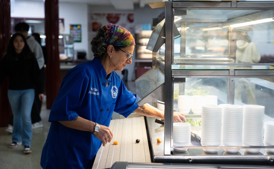 Great Valley School District culinary coordinator Jenifer Halin cleans up the salad bar in the cafeteria at Great Valley High School in Malvern, Pennsylvania.