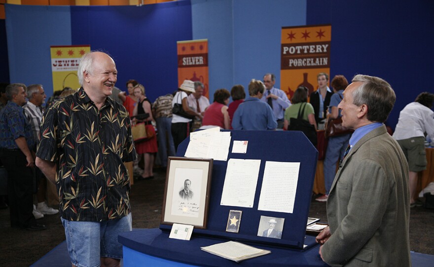 Ken Gloss (right) appraises a U.S. Secret Service archive, ca. 1900, in Palm Springs, Calif. 