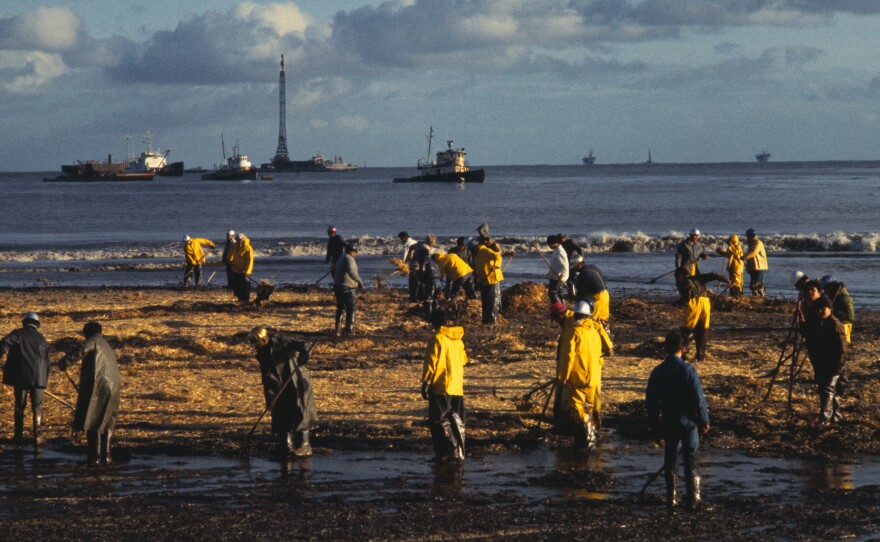 Cleanup workers rake oil-soaked hay along a Santa Barbara beach in 1969, after an oil spill that was then the largest in U.S. history.