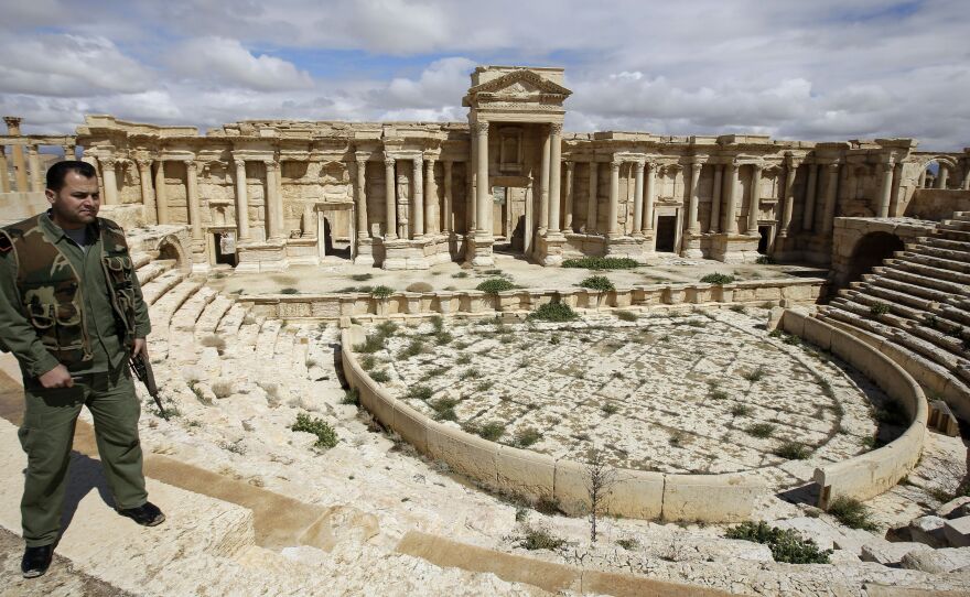 A Syrian policeman patrols the ancient oasis city of Palmyra in March. Many Syrian antiquities have been looted and smuggled out of the country during the past three years of civil war.