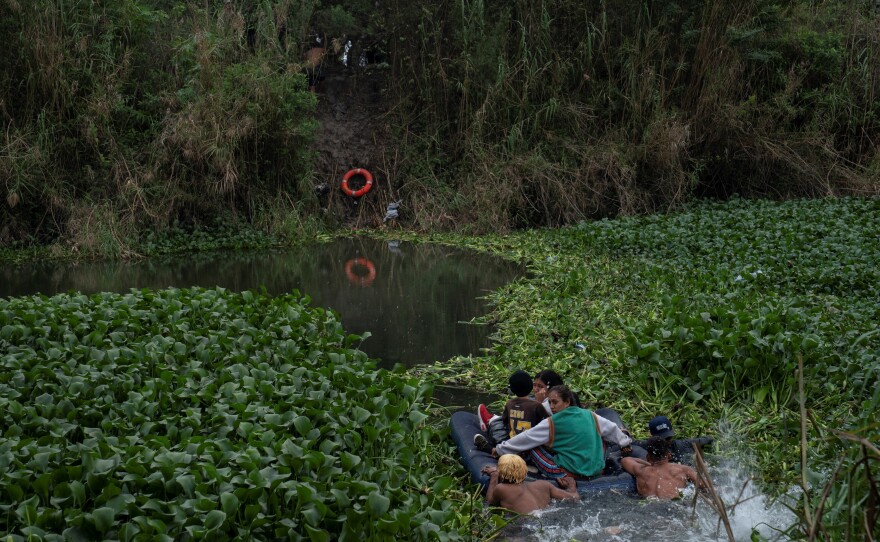 Asylum seekers cross the Rio Grande River into Brownsville, Texas, on Dec. 22.