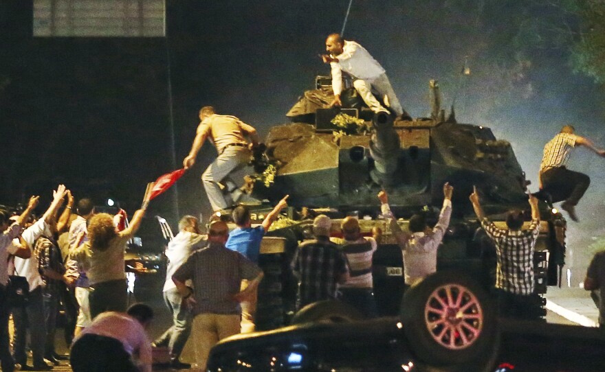 A tank moves into position as Turkish people attempt to stop it early Saturday in Ankara, Turkey.