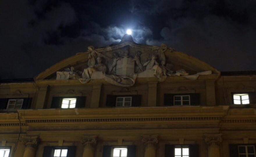 The moon shines as it rises above Italy's finance and economy ministry in Rome, Italy, on Monday. 