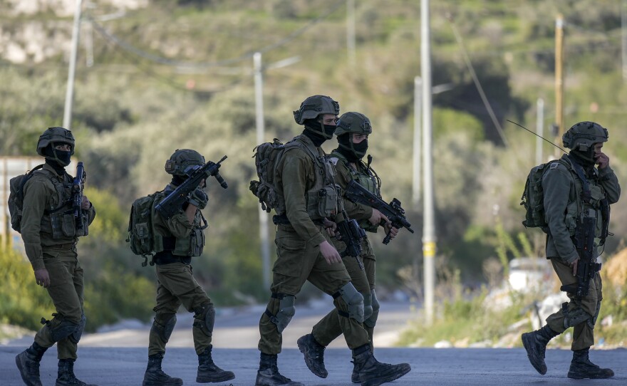 Israeli soldiers operate in village of Sarra near the Palestinians West Bank city of Nablus, Sunday, March 12, 2023. Israeli forces fatally shot three Palestinian gunmen who opened fire on troops in the occupied West Bank. It was the latest bloodshed in a year-long wave of violence in the region.