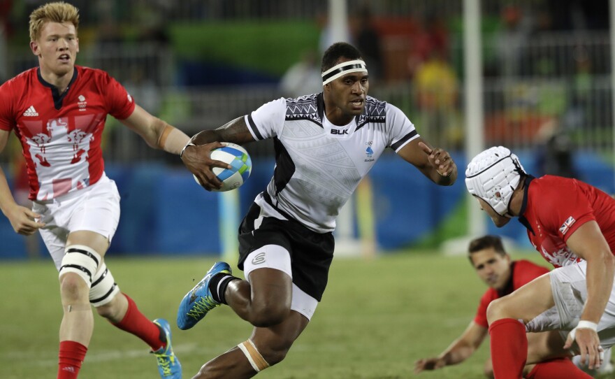 Semi Kunatani of Fiji sprints with the ball in the gold medal match against Britain in men's rugby sevens on Thursday. Fiji routed Britain, 43-7, to win its first gold medal as rugby returned to the Olympics for the first time since 1924.