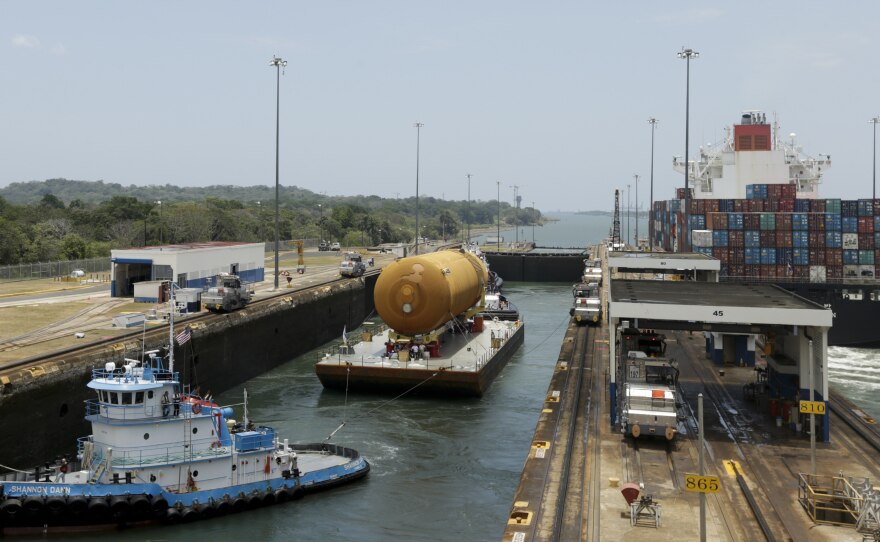 The tugboat and barge transporting NASA's only remaining space shuttle external tank, makes it through the Gatun locks of the Panama Canal, Panama, in April.