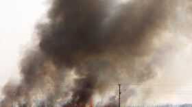 In this photo taken from the Turkish side of the border between Turkey and Syria, in Akcakale, Sanliurfa province, southeastern Turkey, smoke billows from fires on targets in Tel Abyad, Syria, caused by bombardment by Turkish forces, Sunday, Oct. 13, 2019. 