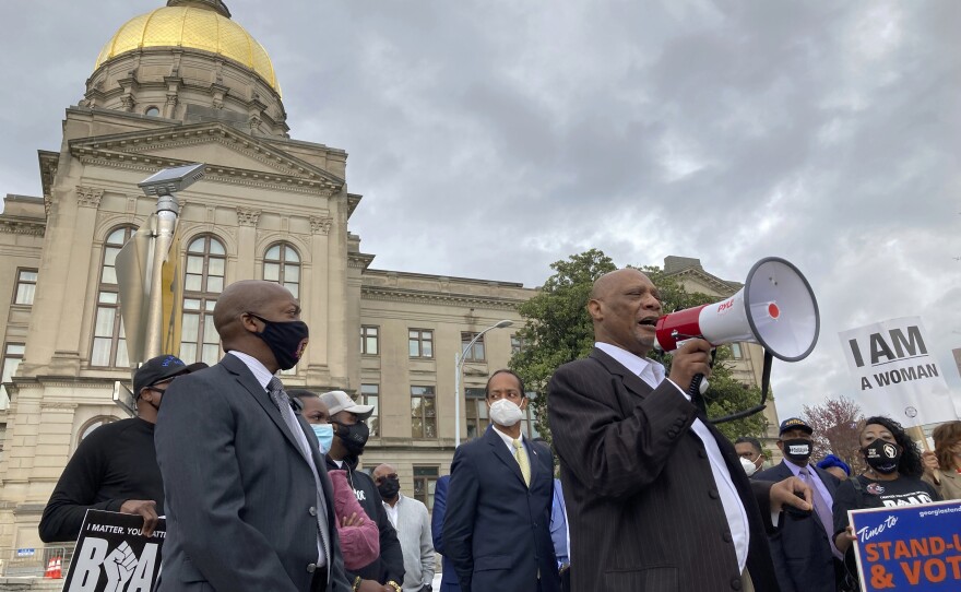 African Methodist Episcopal Church Bishop Reginald Jackson announces a boycott of Coca-Cola products outside the Georgia State Capitol in Atlanta on March 25 because he said Coca-Cola and other large Georgia companies hadn't done enough to oppose restrictive voting bills. Coca-Cola spoke out against a voting bill after it was signed into law.