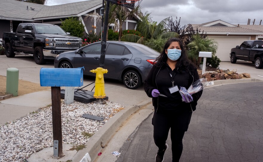 Deysi Merino from Poder Popular, spent the morning walking door to door in Vista dropping off flyers in English and Spanish to educate people about the COVID vaccine, October 25, 2021.<br/>