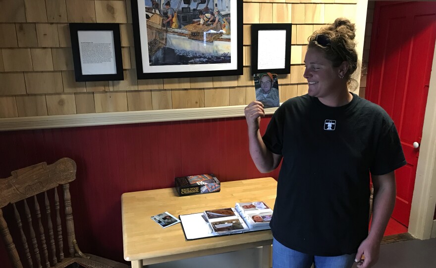 Lobsterman Meredith Oliver with a photo of her grandfather Lee, who taught her to fish and whose lobster boat she inherited at age 15 after his death. Now she's 28 and her plan is to do whatever it takes to keep lobstering.