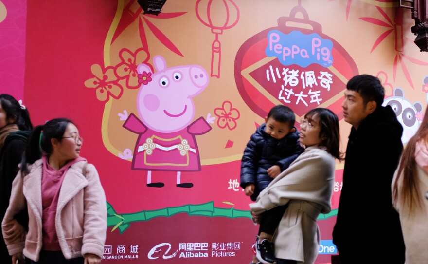 People walk past a Peppa Pig pop-up shop in the Yu Yuan gardens, a popular tourist spot in Shanghai.
