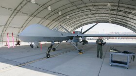 United States Air Force Maj. Casey Tidgewell gets an MQ-9 Reaper ready for a training flight August 8, 2007 at Creech Air Force Base in Indian Springs, Nevada. The Reaper is the Air Force's first 'hunter-killer' unmanned aerial vehicle (UAV) and is designed to engage time-sensitive targets on the battlefield as well as provide intelligence and surveillance.