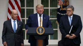 President Donald Trump, joined by Commerce Secretary Wilbur Ross, left, and Attorney General William Barr, speaks during an event about the census in the Rose Garden at the White House in Washington, Thursday, July 11, 2019. 