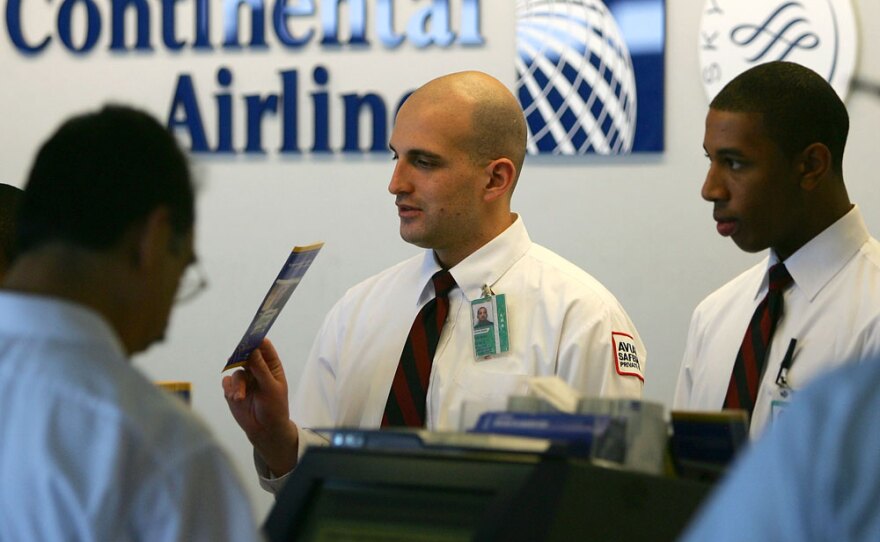 Continental Airlines agents help passengers with ticketing at Los Angeles International Airport June 5, 2008 .