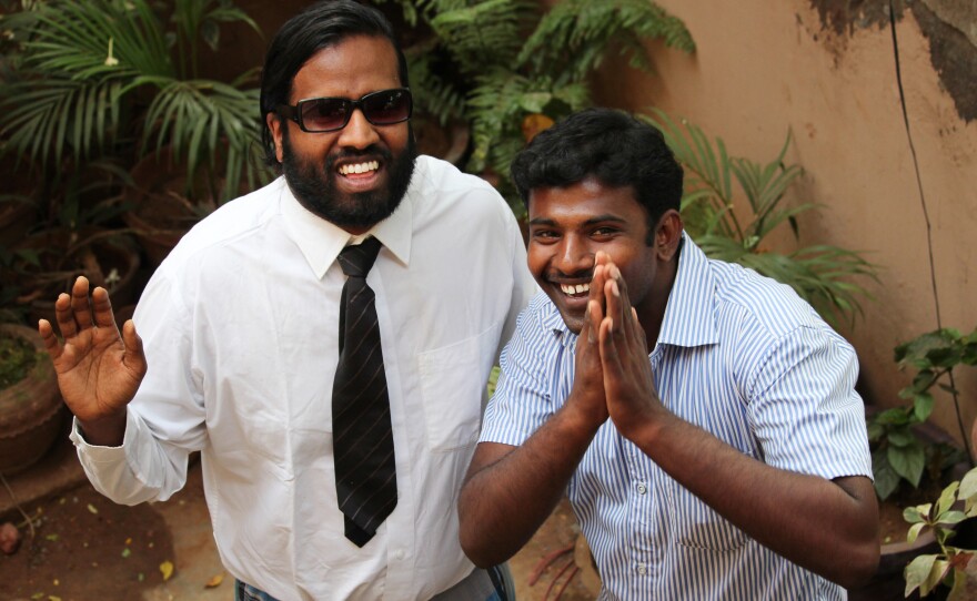 Our correspondent Wilbur Sargunaraj, clad in his trademark lunghi pants, poses with sports-loving Simpson.