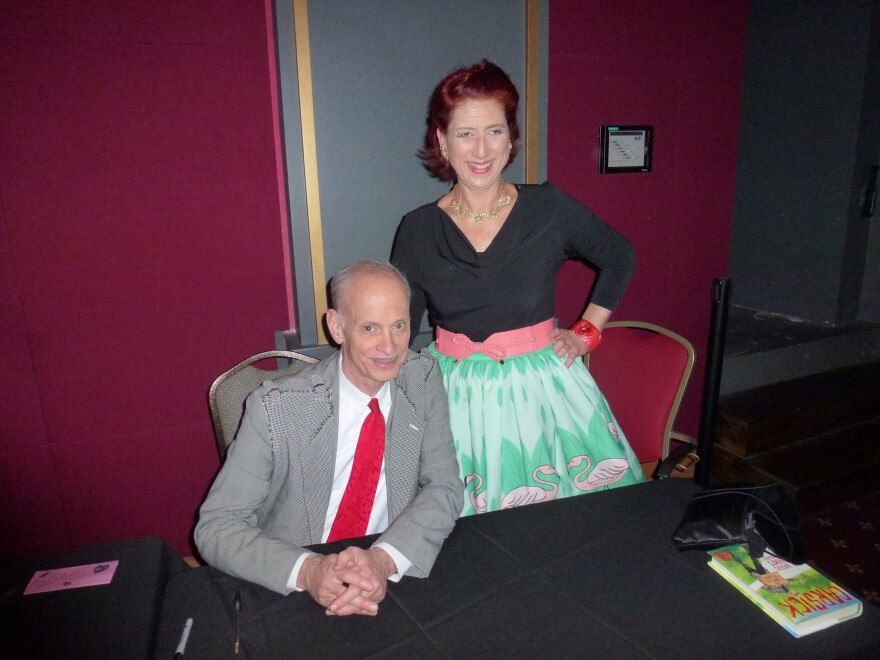 John Waters and KPBS arts reporter Beth Accomando at his 2014 Christmas show. Dec. 2, 2014