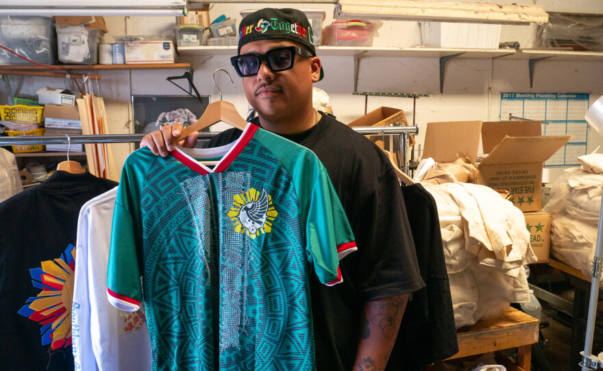 Moss Randy Ortega holds a jersey he designed and sold during the World Cup. Photo taken on Aug. 3, 2026.