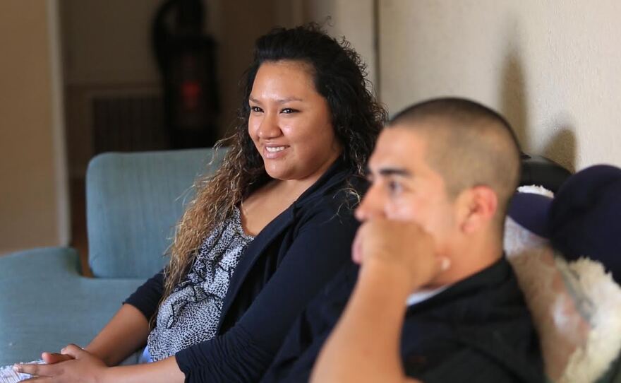 Victorugo Rodriguez Tello, right, sits with his wife, Estefani Madagan, on a couch, May 22, 2015.