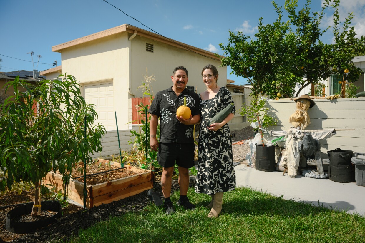 Johnny and Allison Calderon stand for a portrait in their garden in National City, California on October 13, 2025. The Calderon's said the garden wouldn’t have been possible without the National City Public Library’s tool lending program.