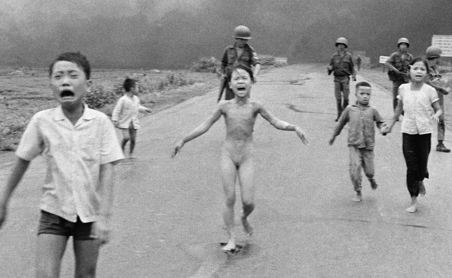 South Vietnamese forces follow terrified children, including 9-year-old Kim Phuc (center), as they run down Route 1 near Trang Bang after an aerial napalm attack on suspected Viet Cong hiding places, June 8, 1972.