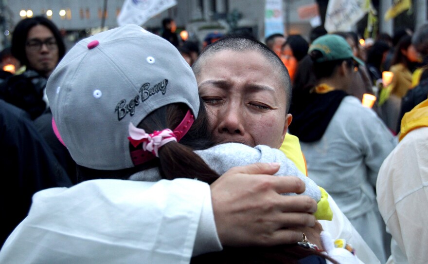 A relative of a victim of the Sewol ferry receives a hug during a rally earlier this month in Seoul. A year after the disaster that killed 304, parents of the victims are still demanding an independent investigation and recovery of the boat.