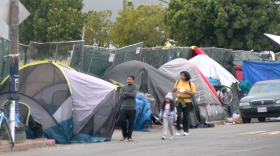 School children walking in the street to avoid homeless encampments on National Street in downtown San Diego on May 30, 2023.