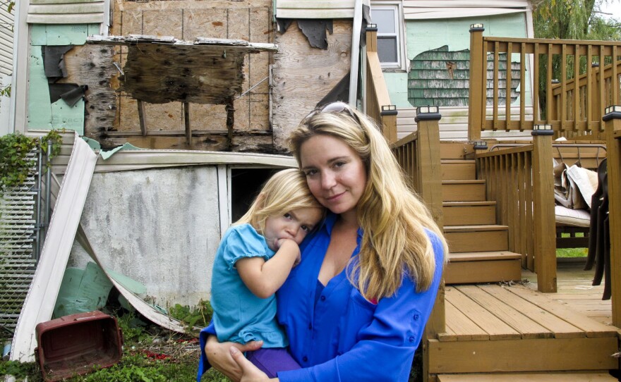 Samantha Langello and her daughter Alanna, 2, stand in front of their flood-damaged house in Fox Beach on Staten Island, N.J.