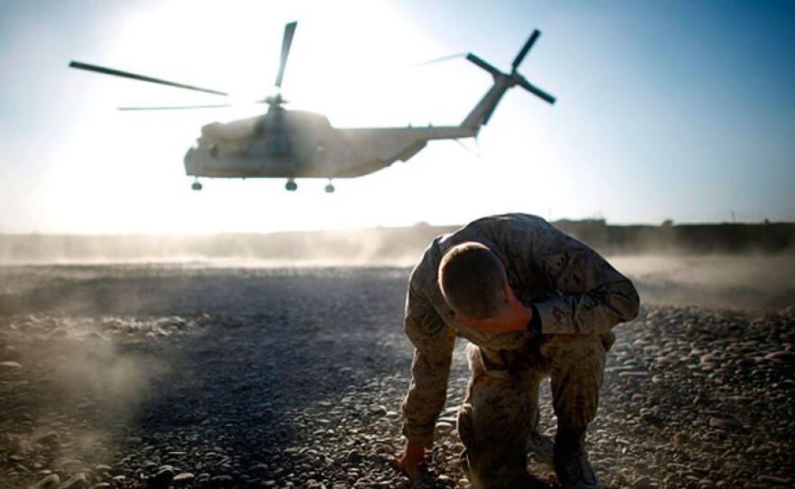 Lt Col. Christian Cabaniss, the top command for the Marine's 2nd Battalion, 8th Regiment, covers his eyes and hits the ground as a Marine helicopter lifts off last week from Forward Operating Base Delhi in Helmand Province in southern Afghanistan.