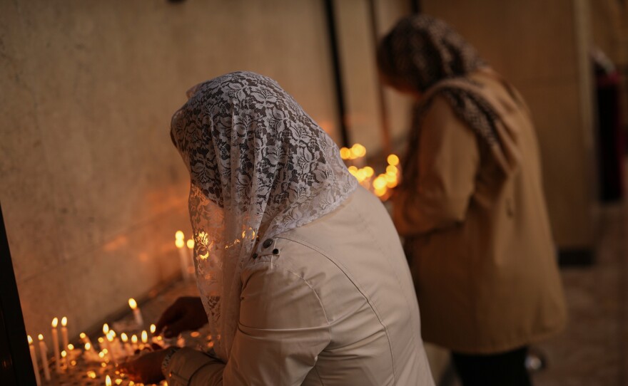 Worshippers light candles during Easter Sunday Mass at Saint Sarkis Cathedral, an Armenian Apostolic church, in Tehran, Iran, Sunday, April 5, 2026.