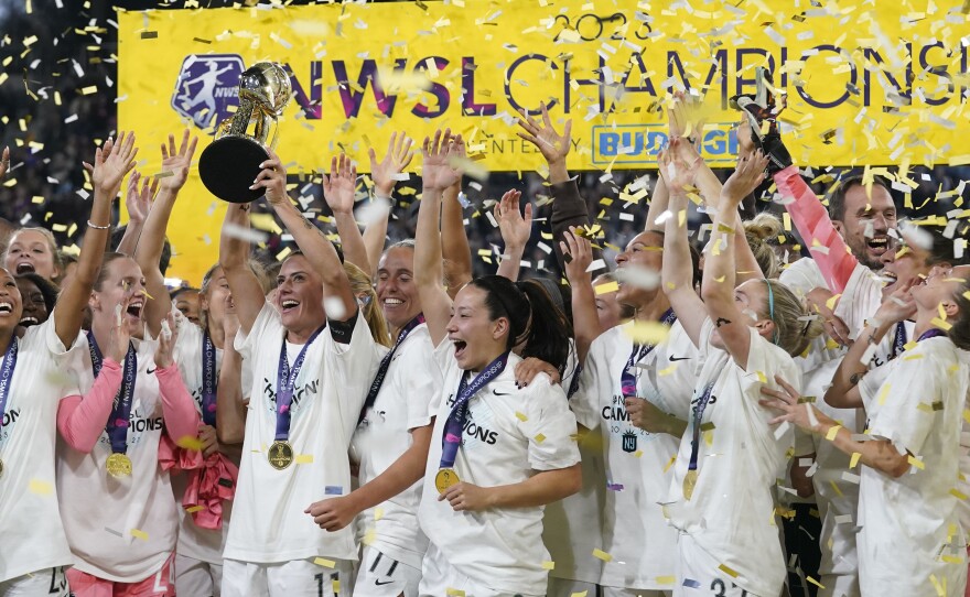 NJ/NY Gotham defender Ali Krieger holds the trophy after NJ/NY Gotham defeated OL Reign 2-1 in the NWSL Championship soccer game, Saturday, Nov. 11, 2023, in San Diego.