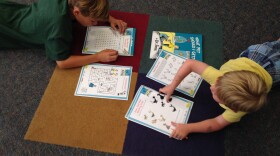 Two young boys complete Dr. Seuss-related activity pages at the UC San Diego Geisel Library celebration of the new book, July 28,2015.