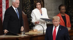 President Donald Trump turns after handing copies of his speech to House Speaker Nancy Pelosi of Calif., and Vice President Mike Pence as he delivers his State of the Union address to a joint session of Congress on Capitol Hill in Washington, Tuesday, Feb. 4, 2020.
