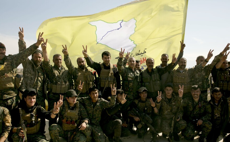 U.S.-backed Syrian Democratic Forces (SDF) fighters pose for a photo in Baghouz, Syria, in March after the SDF declared the area free of Islamic State militants.