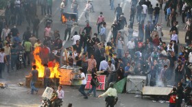 Supporters of Iran's defeated presidential candidate Mir Hossein Mousavi set burning barricades in the streets as they protest during a demonstration.