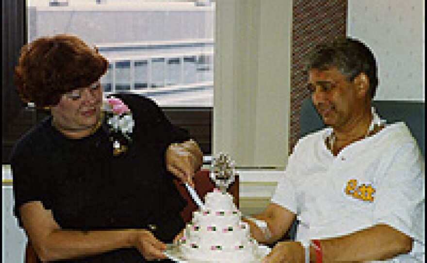 Paul Jewell and his wife, Joy, celebrate their anniversary in June 1993 nearly four months before he received a heart transplant. Jewell is attached to a heart machine located underneath his shirt.