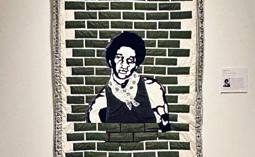 Tyler's quilt titled, Captivity, 1974 (2023) is based on a photo his brother took of him at the St. Charles Parish jail, one month after he was arrested and charged with the murder of a white 13-year-old. He was still wearing the clothing he was arrested in.