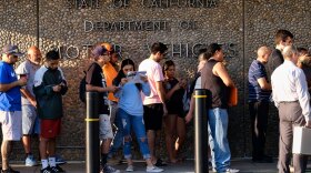 In this Aug. 7. 2018 file photo people line up at the California Department of Motor Vehicles prior to opening in the Van Nuys section of Los Angeles.