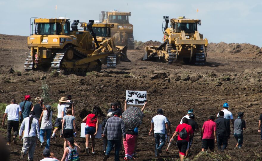 Protestors approach construction crews during a demonstration against work being done for the Dakota Access Pipeline near Cannon Ball, N.D., on Sept. 3, 2016.