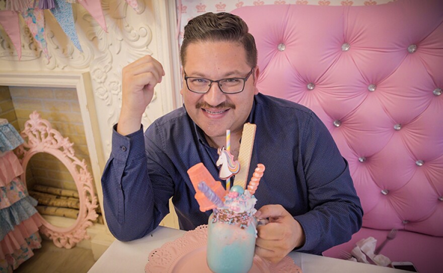 Host Jorge Meraz gets ready to enjoy a unicorn malt at a restaurant in Tijuana called Princess Tea Party Glamour.