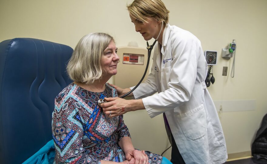 Rice checks Mary Heafy's breathing during a checkup for her asthma at the Beth Israel Deaconess clinic. Climate change does seem to be extending the Boston region's ragweed season, Rice tells Heafy.
