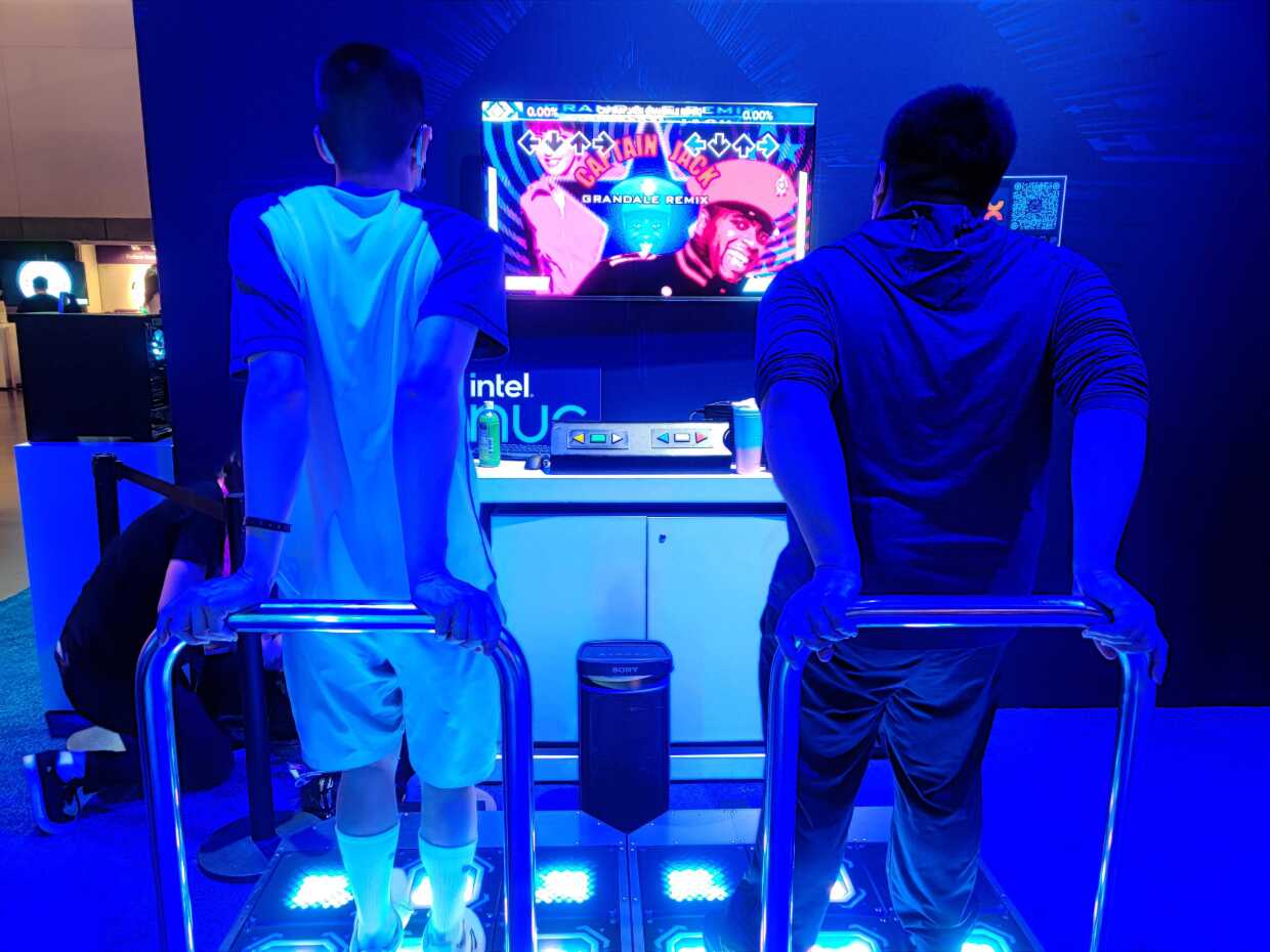 Two attendees play a dance videogame at TwitchCon, Oct. 9, 2022.