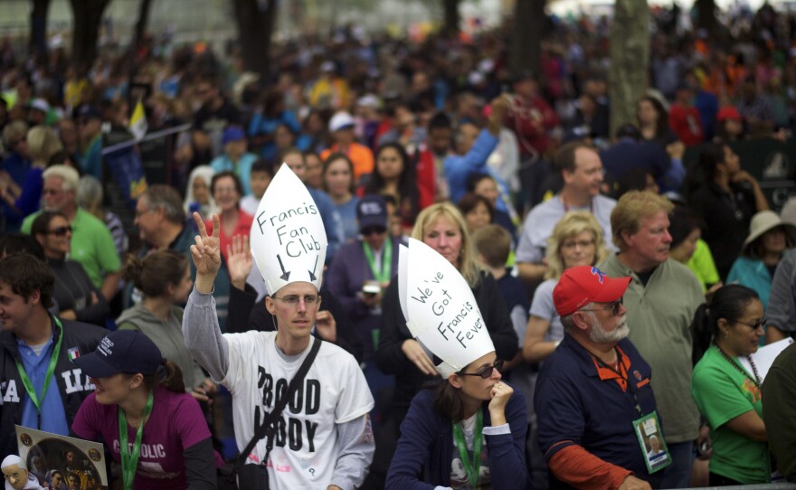 People gather on the Benjamin Franklin Parkway for the papal Mass on the final day events with Pope Francis in Philadelphia, on Sunday. After six days in the U.S., Francis returns to Rome Sunday evening.